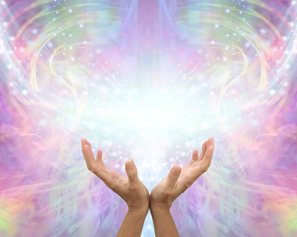 What Angel Number 6 Reveals About Your Spiritual Path Two hands reaching upward, holding radiant light surrounded by rainbow colors and sparkles, symbolizing divine support and the healing energy behind Angel Number 6.
