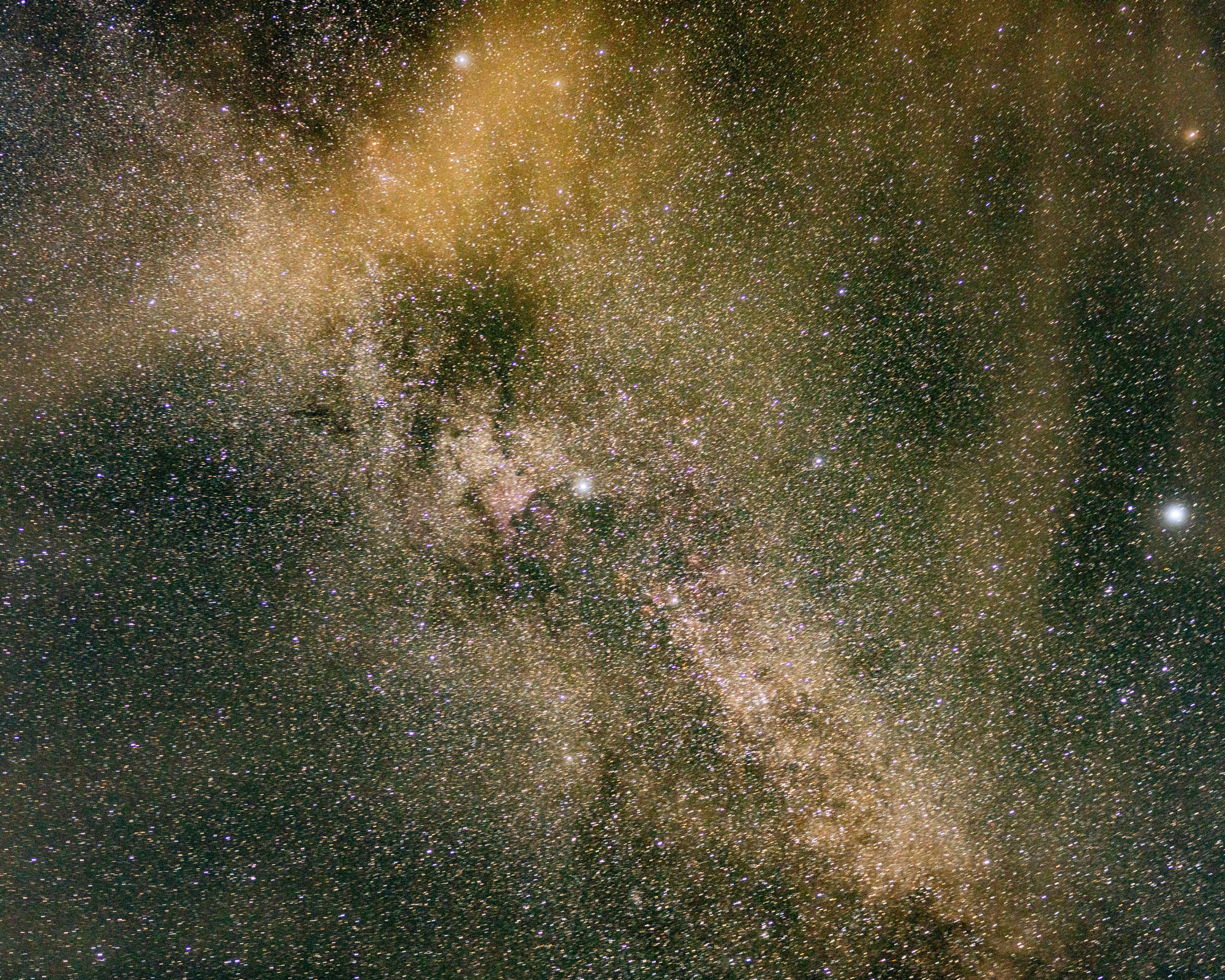 A dense star field filled with golden and violet tones, reflecting the vastness of the universe and the celestial energy of the galactic chakra.