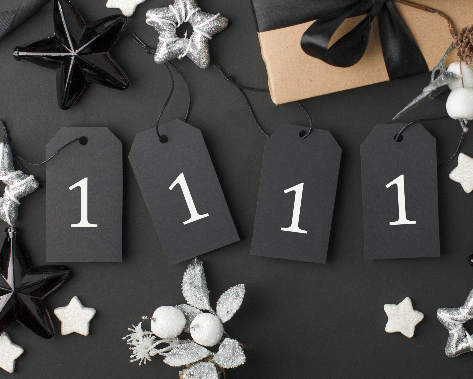 Angel Numbers 11 11 Four black gift tags displaying the number 1111 surrounded by stars and decorations, symbolizing subtle signs of 11 11 angel numbers appearing in daily life.