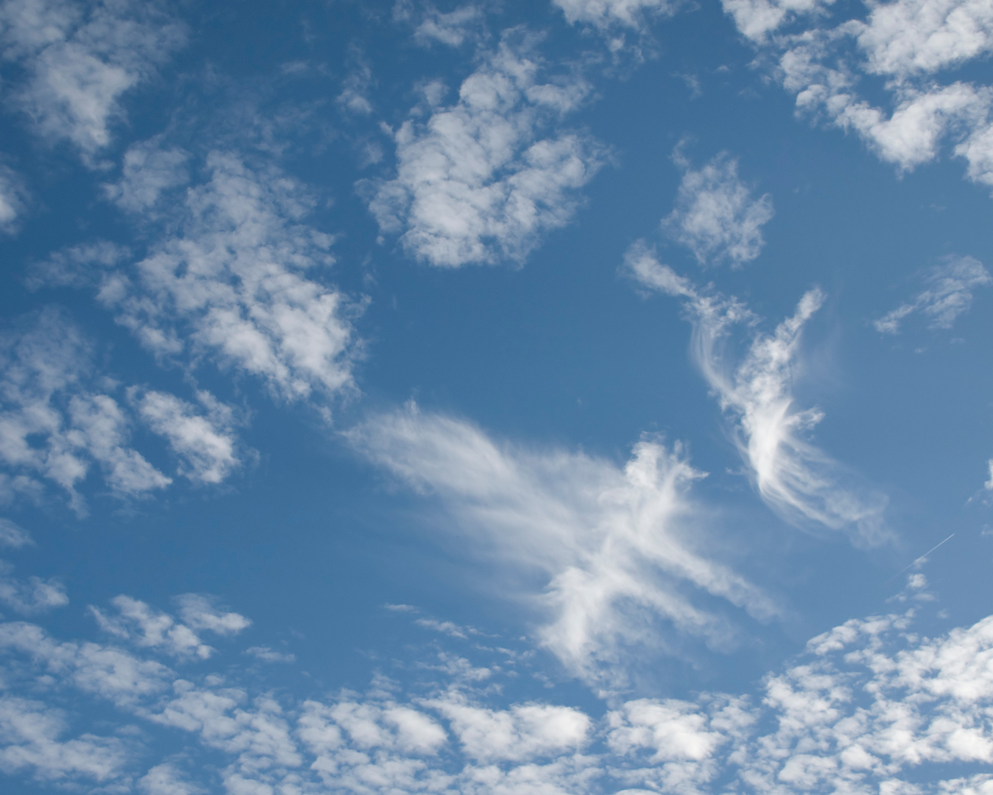 All Angel Numbers: The Guide to Angel Numbers and What They Mean Sky with soft white clouds shaped like angelic figures, capturing the spiritual symbolism and subtle signs connected to angel numbers and what they mean.