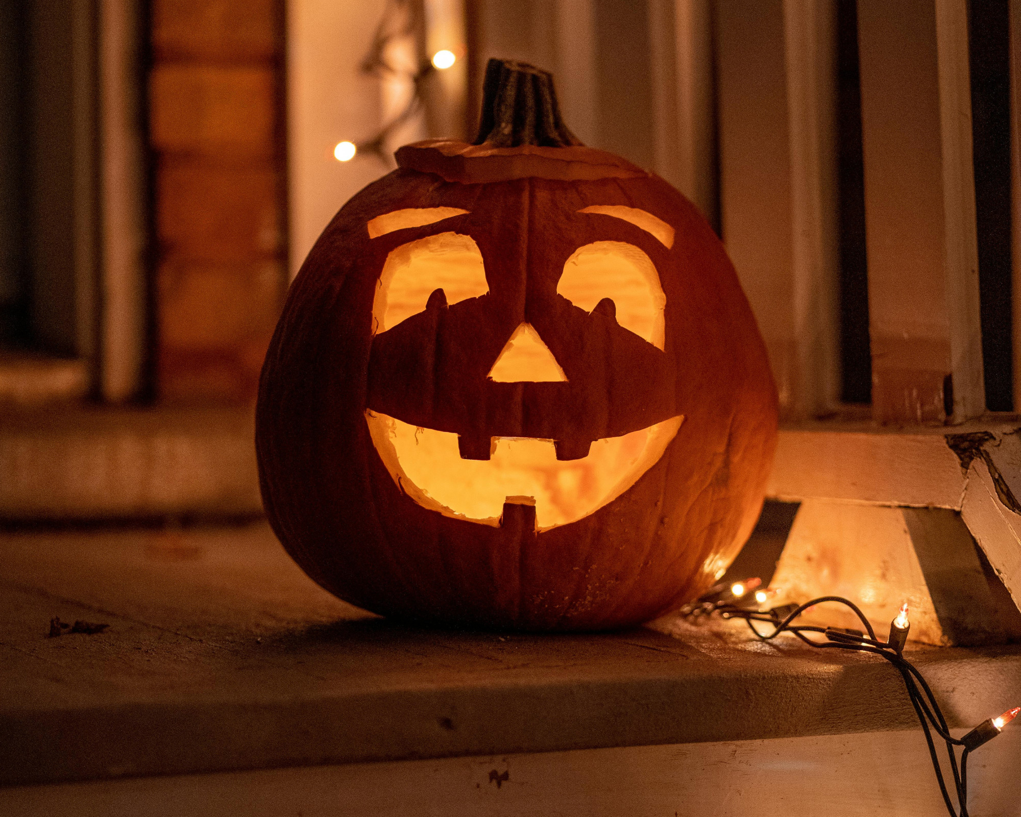 A carved pumpkin lit from within, symbolizing protection and guiding spirits, and offering ideas on what to do for Samhain at home.