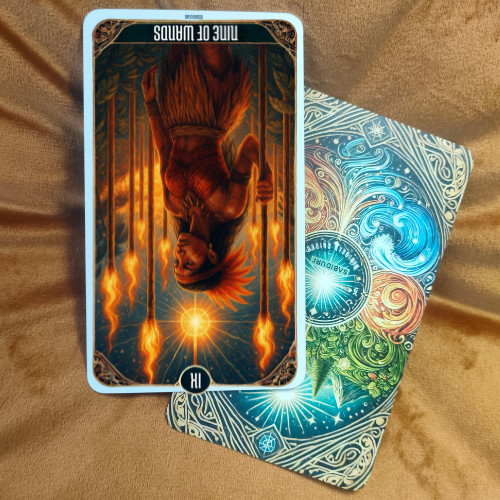 9 of Wands Tarot Card Meaning - Minor Arcana Tarot Card Meanings 9 of Wands tarot card meaning illustrated by an upright card placed on a tarot deck, symbolizing inner strength, boundaries, and defending your truth.