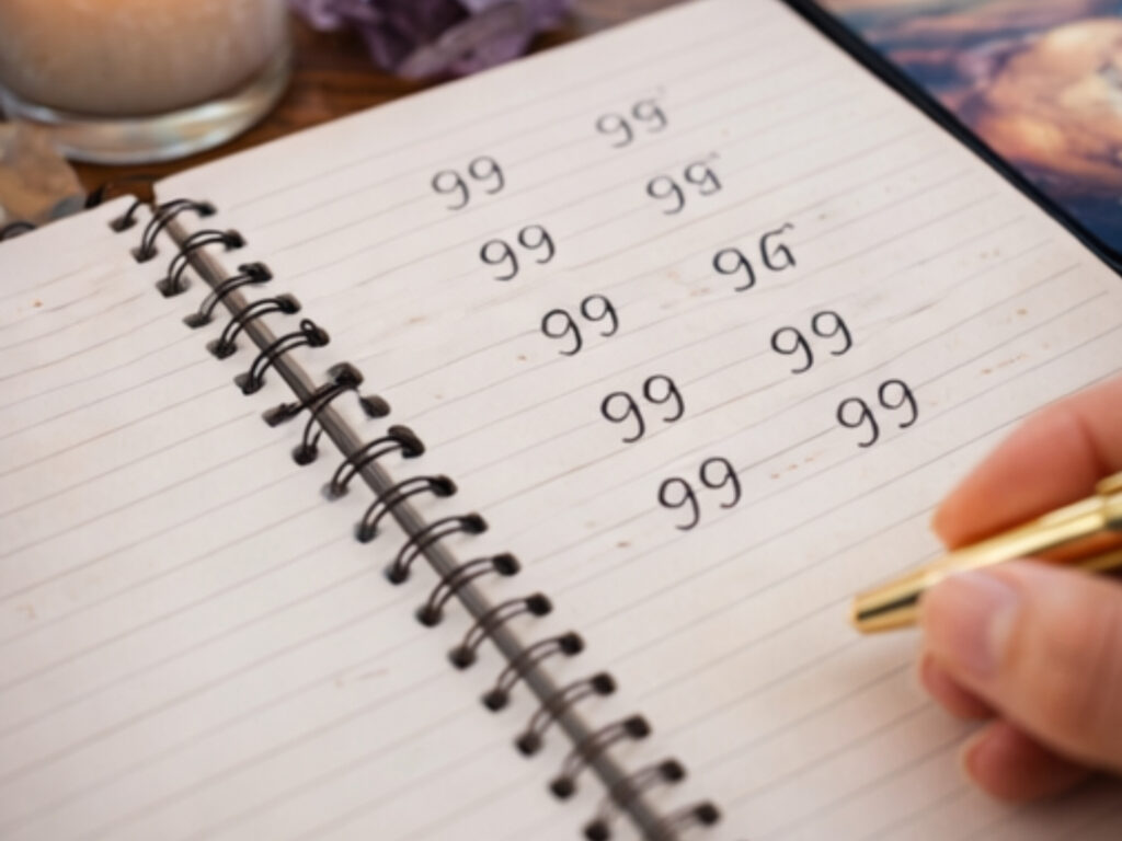 Angel Number 99 Meaning: The Spiritual Ending You Can’t Ignore Notebook page filled with the number 99 written repeatedly, symbolizing angel numbers 99 and spiritual messages of completion.