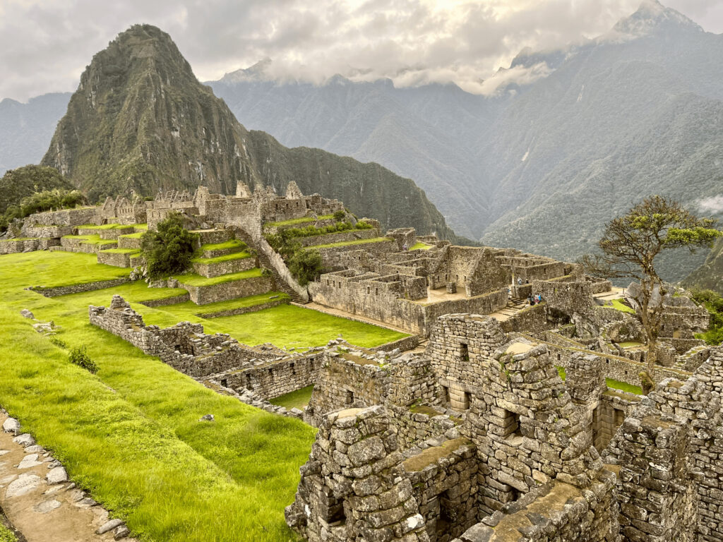 When the Mountains Called Me Home: How Peru Re-Mapped My Inner Compass Historic stone terraces and ruins of Machu Picchu in Peru surrounded by misty Andean mountains.