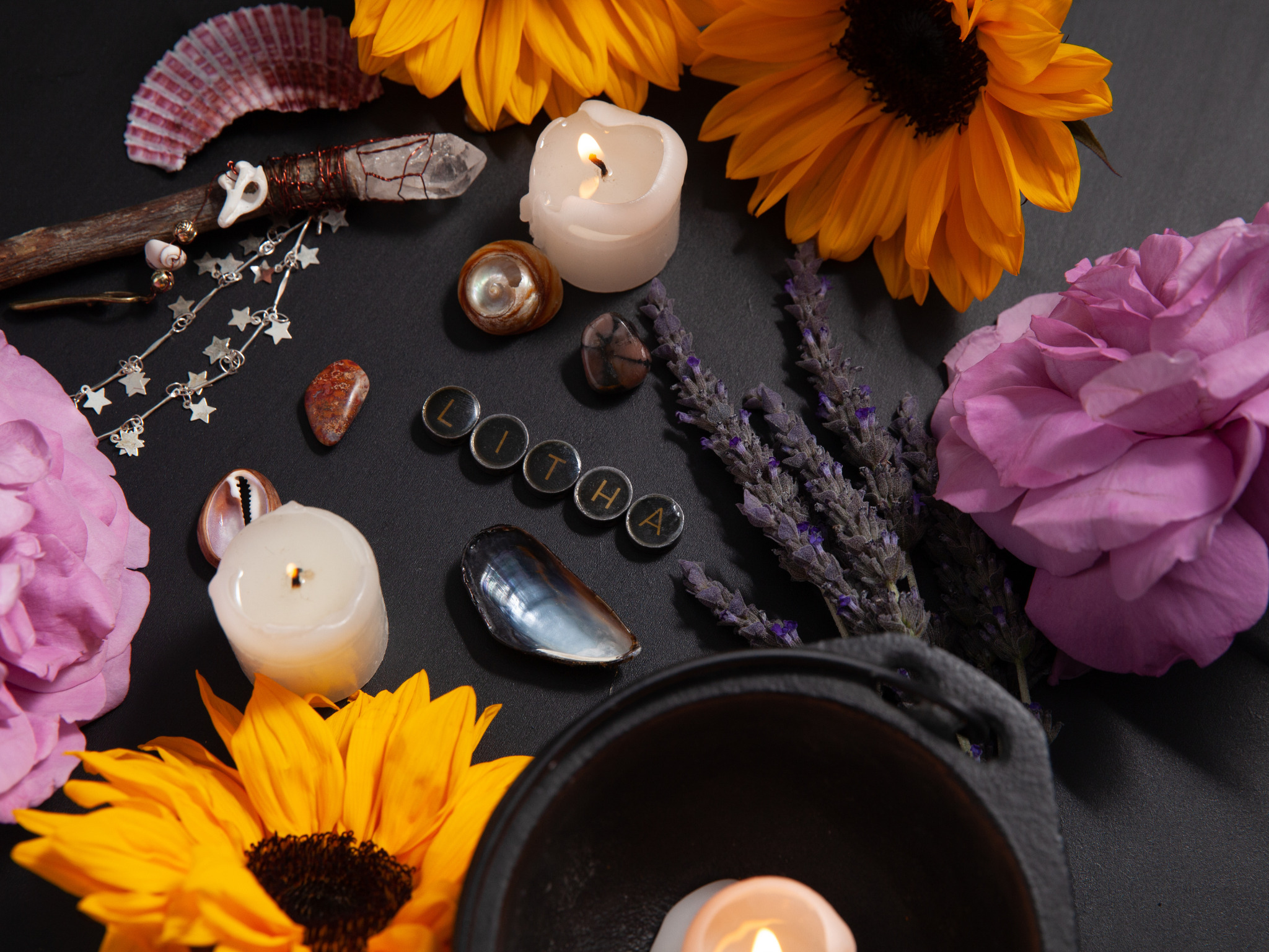 Litha altar decorated with sunflowers, candles, crystals, lavender, and seashells, showing a spiritual setup for how to celebrate Litha.