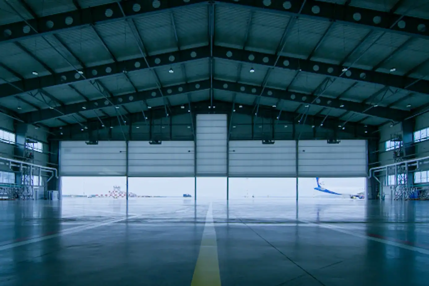 Aircraft hangar door system for aviation infrastructure and airport maintenance facilities