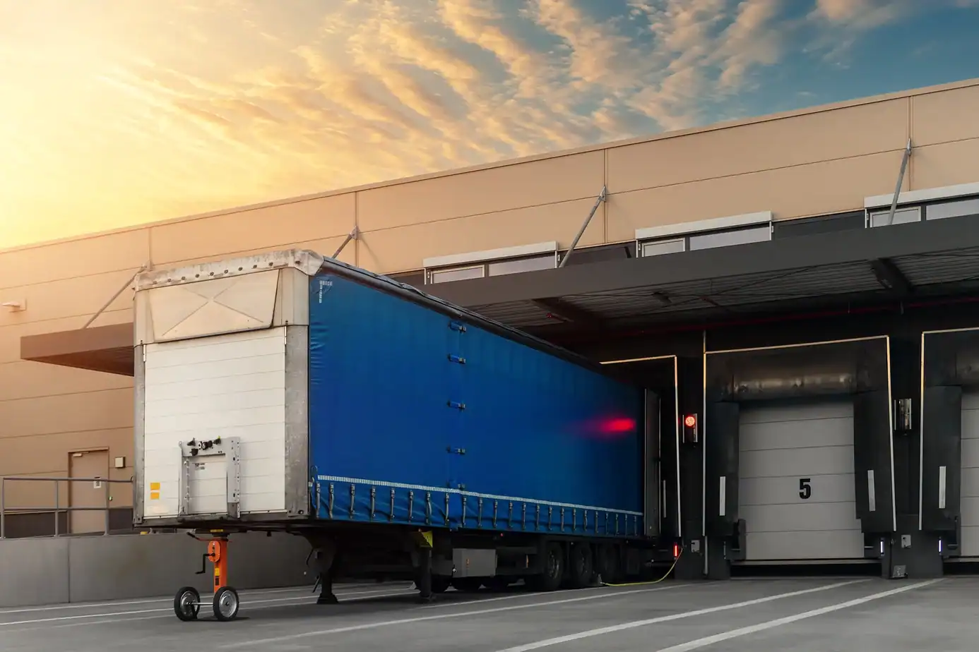 Loading dock doors at warehouse logistics center with truck and dock shelter system
