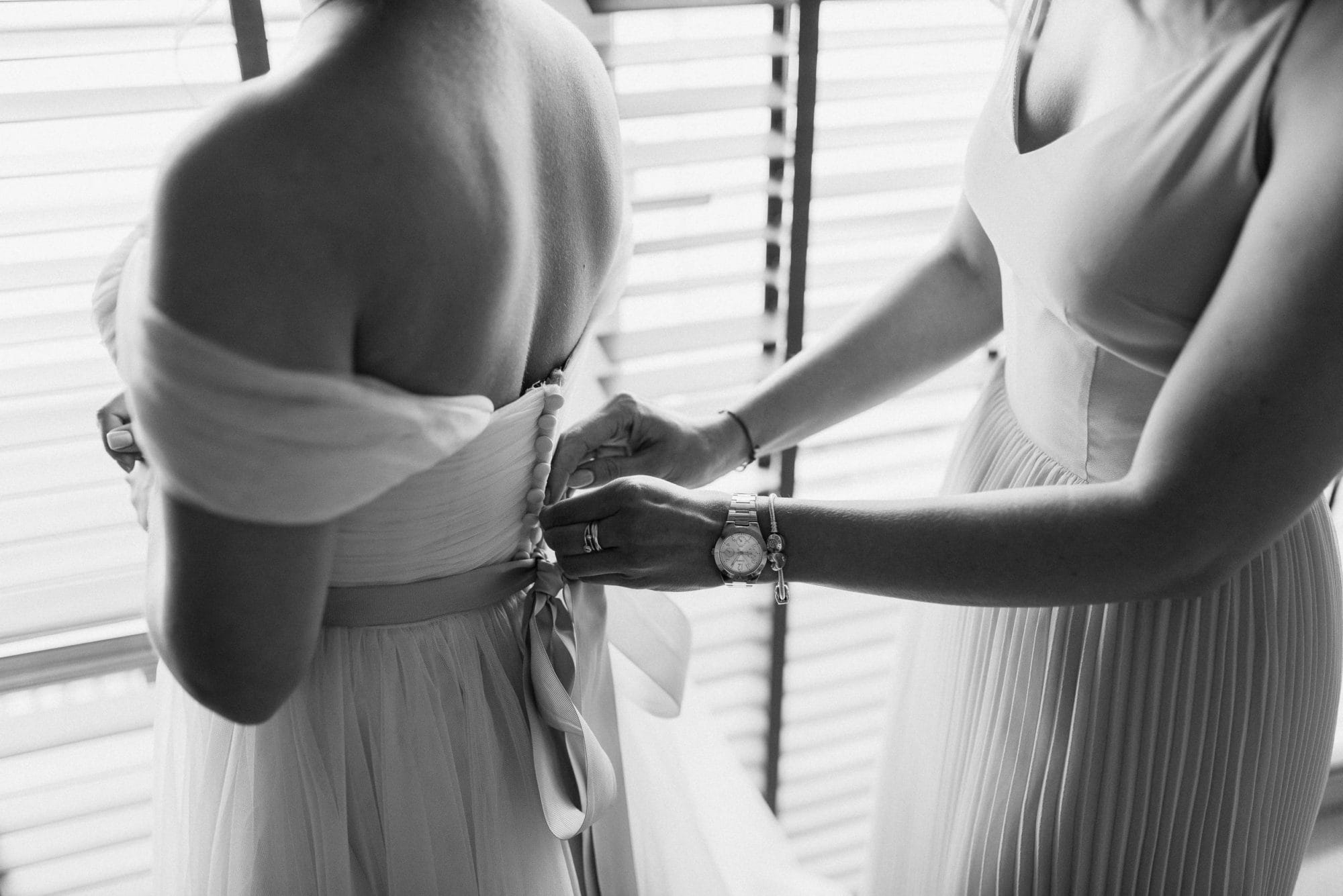 Woman Fixing Dress Of Woman