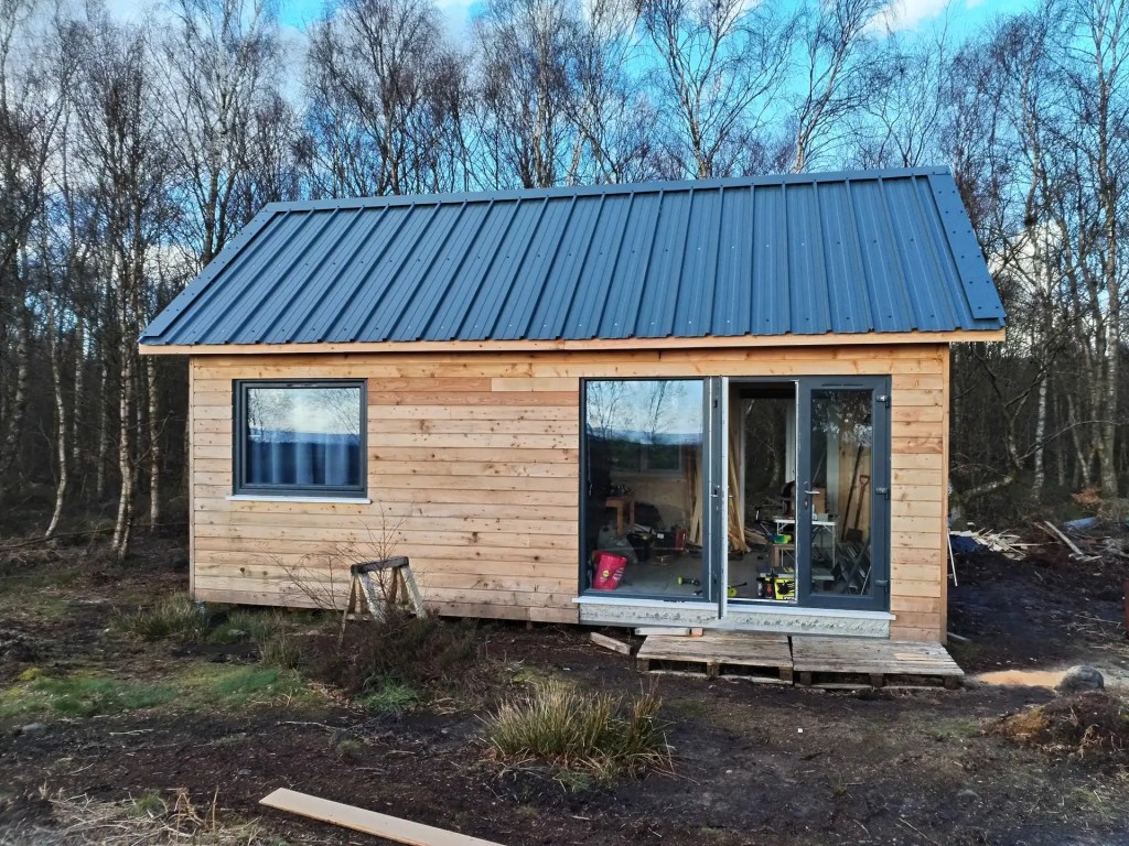 Woodland hut clad in shiplap profiled larch cladding
