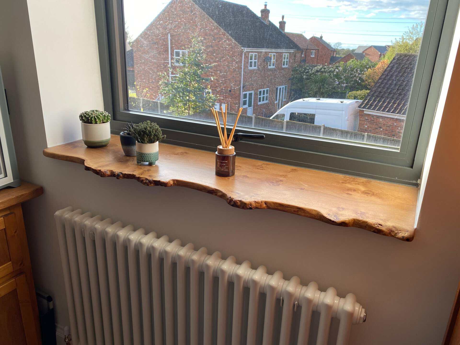 A live edge windowsill made from Scottish oak, with a natural waney edge