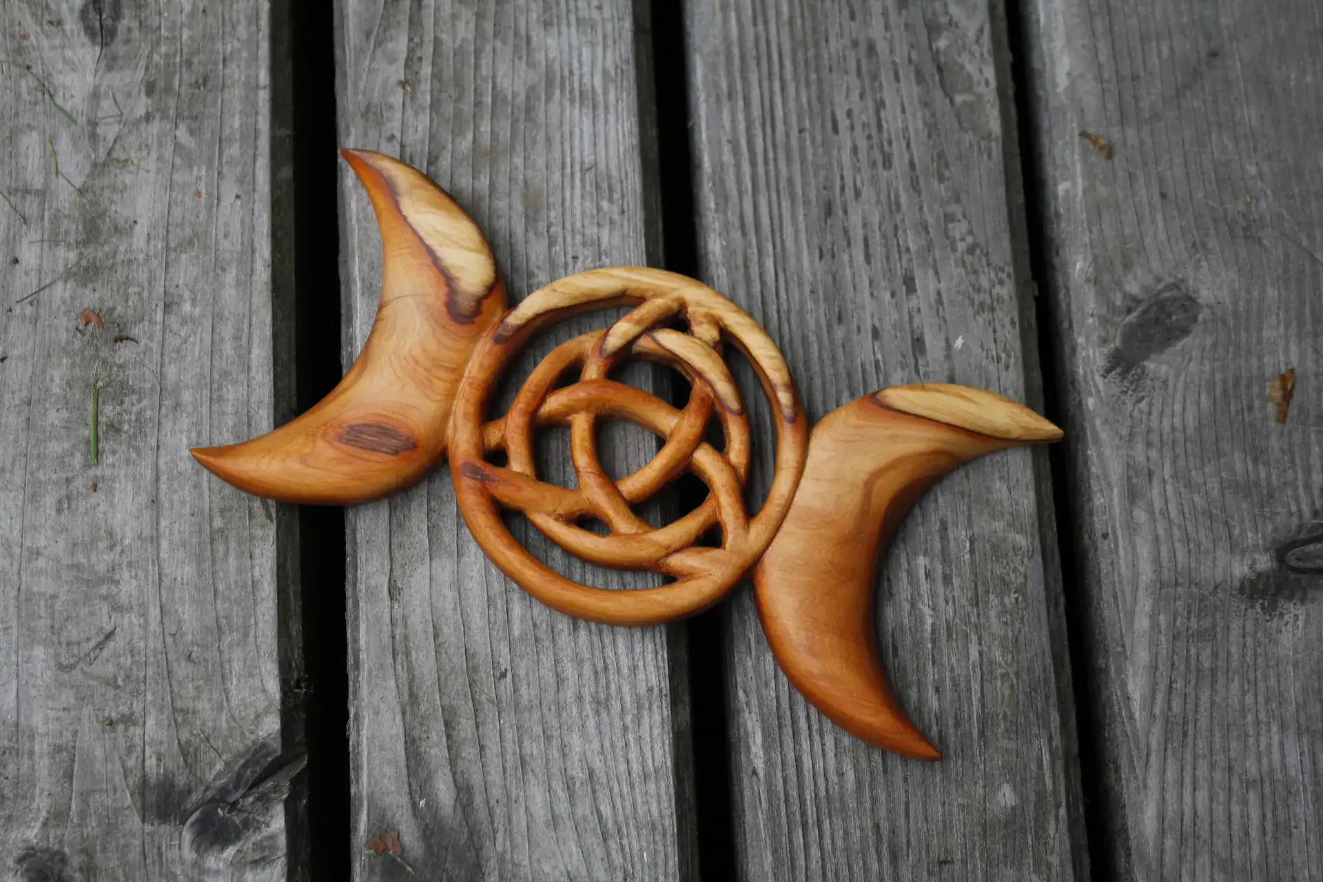 A hand carved triquetra knot and half moon, carved from Scottish Yew by Alba Woodcrafts