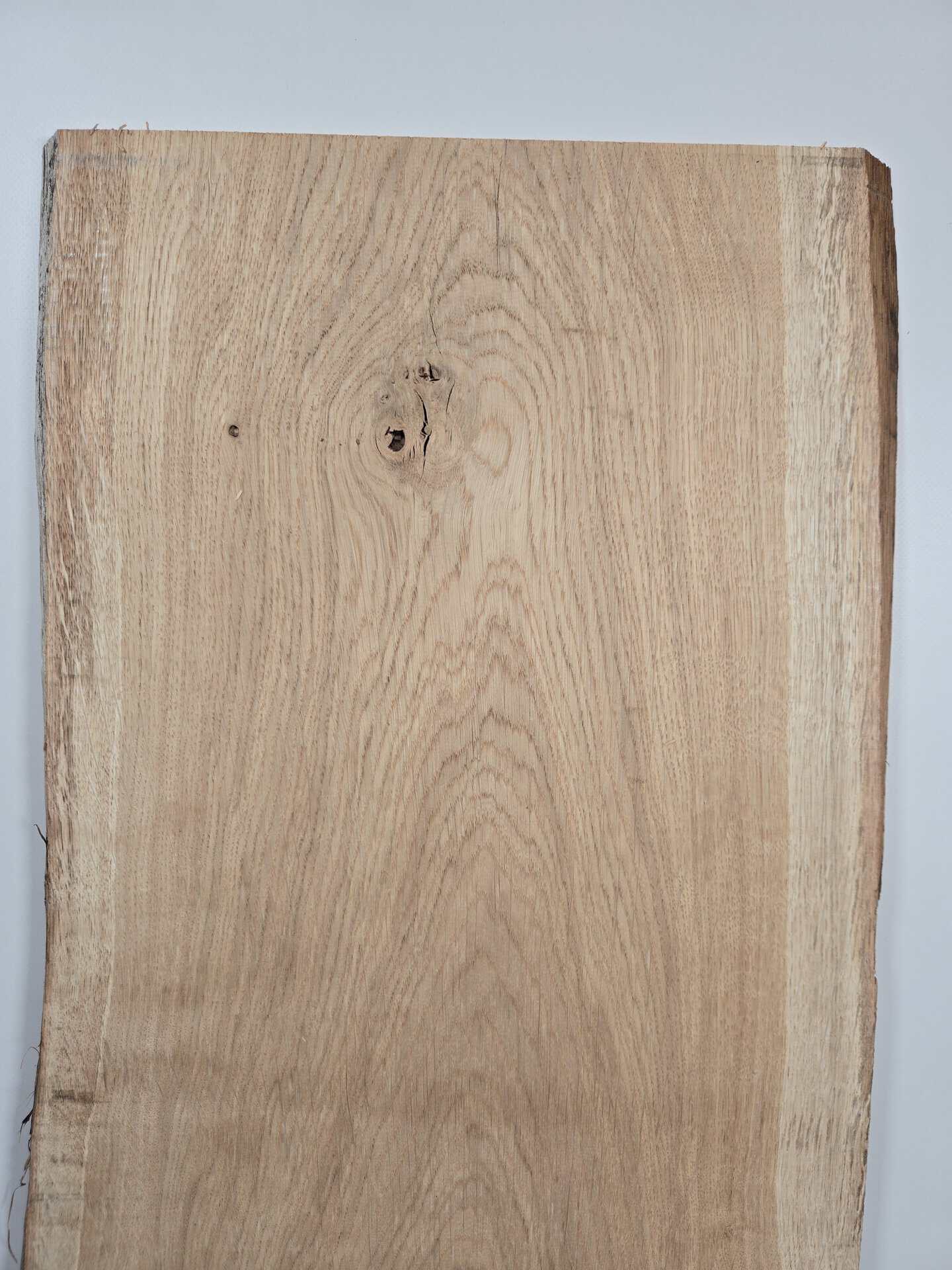 Natural edge Scottish Oak timber board with wavy edge and visible grain pattern.