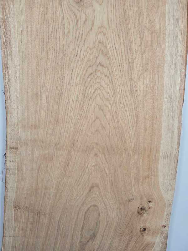 Natural edge Scottish Oak timber board with wavy grain and smooth surface.