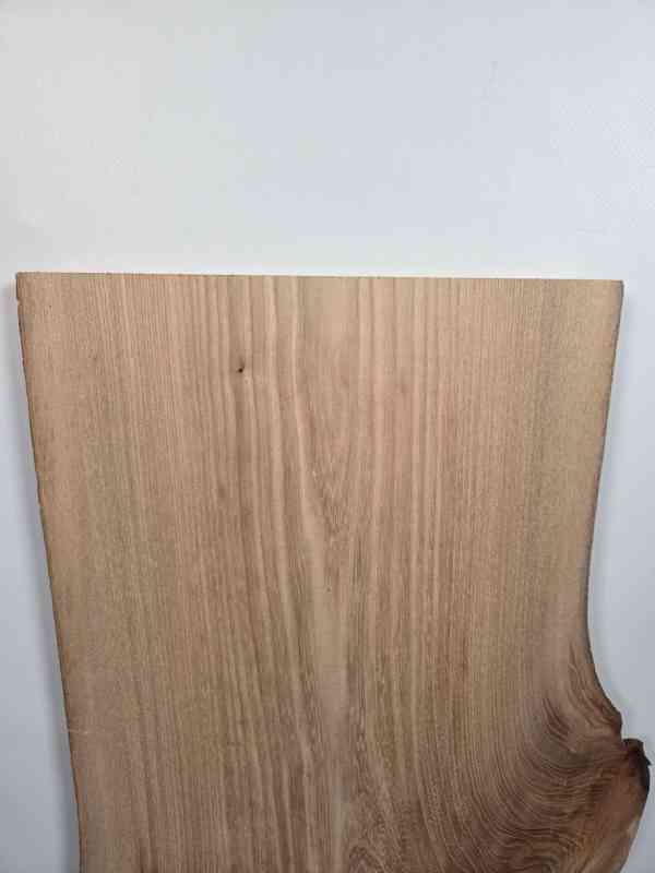Elm offcut with natural edge showing smooth planed surface and wood grain.