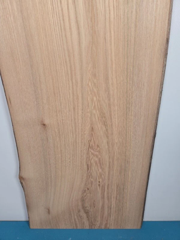 Straight grain Elm offcut showing natural wood texture and light colour.