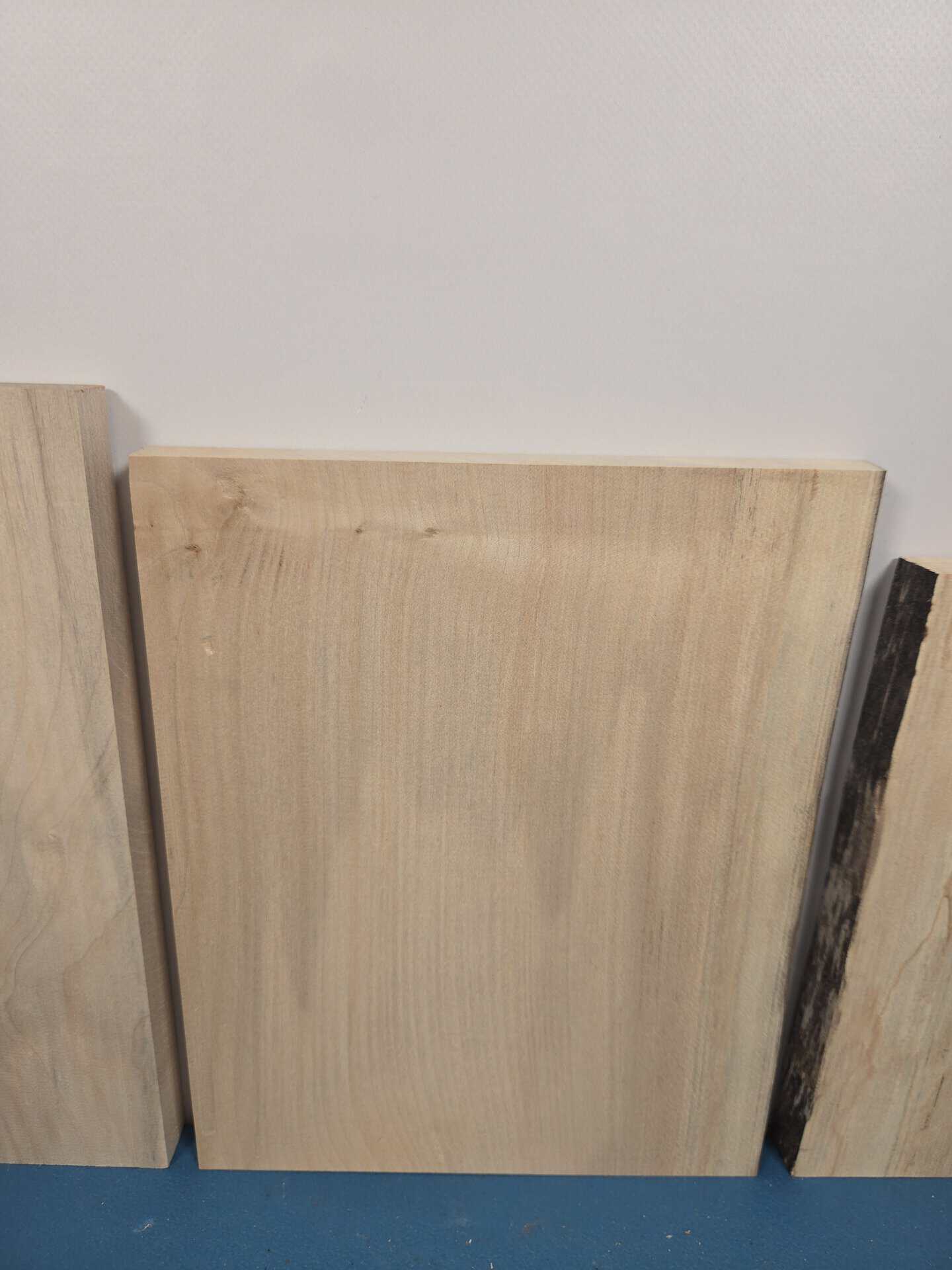 Sycamore offcuts with smooth planed surface and natural wood grain.