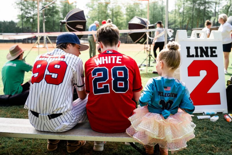 The Perfect EDC Camera - Nikon Zf Kids in sports jerseys sit on a bench.