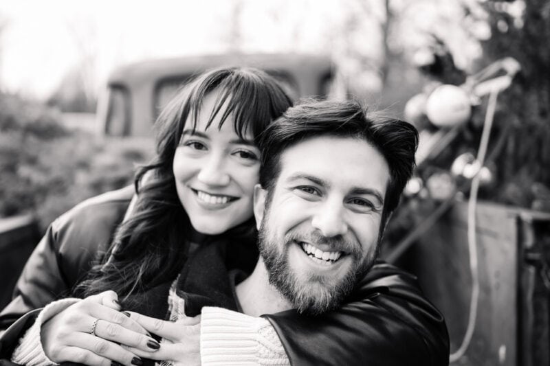 The Perfect Black & White Photo Editing Style Smiling couple hugging outdoors, black and white photo.