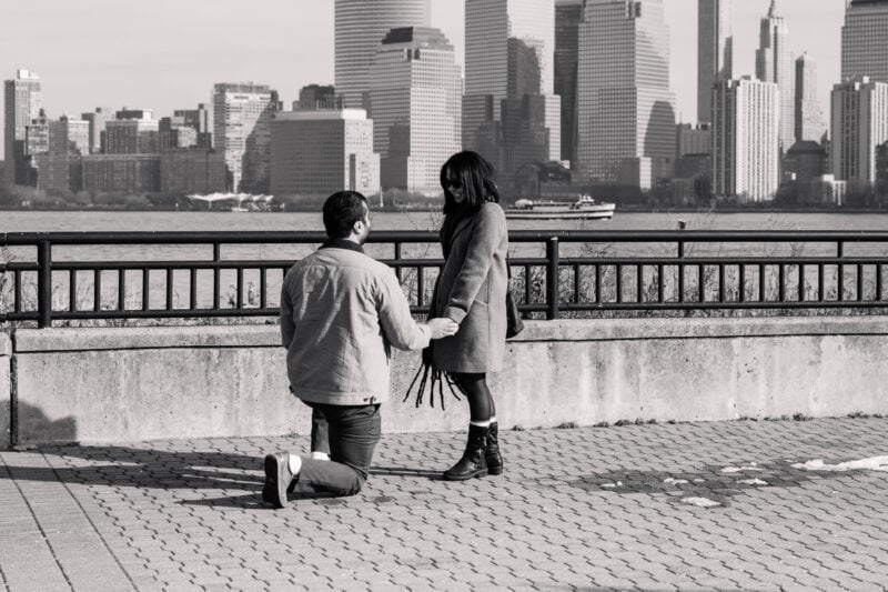 The Perfect Black & White Photo Editing Style Man proposing on waterfront with city skyline.