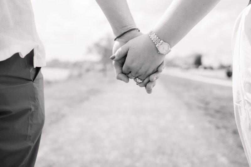 The Perfect Black & White Photo Editing Style Couple holding hands walking outdoors.