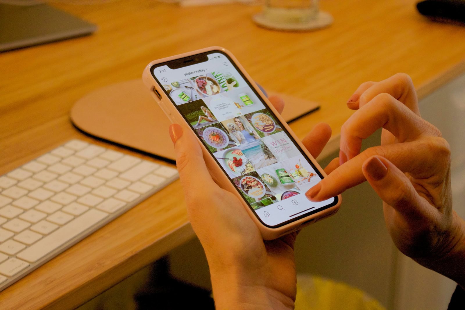 Instagram Stories Tips for Photographers Person browsing Instagram on smartphone at desk