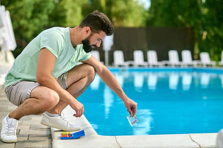 main throwing chemical in pool