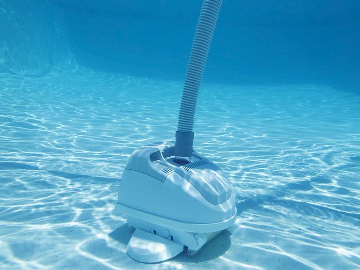 Automated pool cleaner robot at the bottom of a crystal blue pool in Orlando