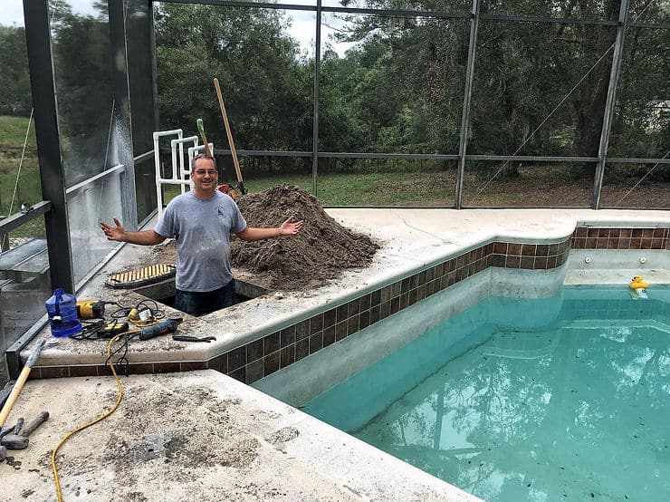 man fixing swimming pool issues