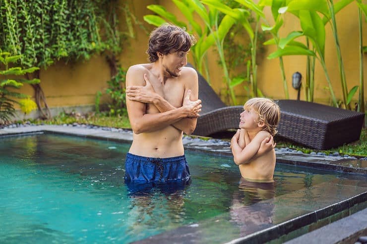 family enjoying pool in winter