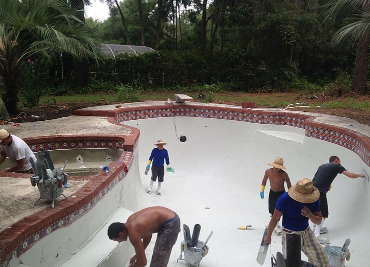 pool resurfacing team doing work