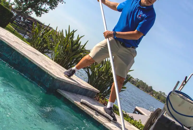 man cleaning swimming pool