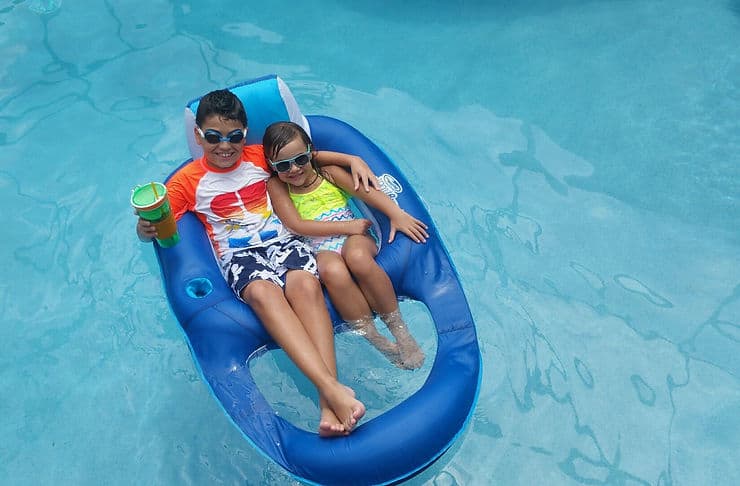 siblings enjoying in a pool
