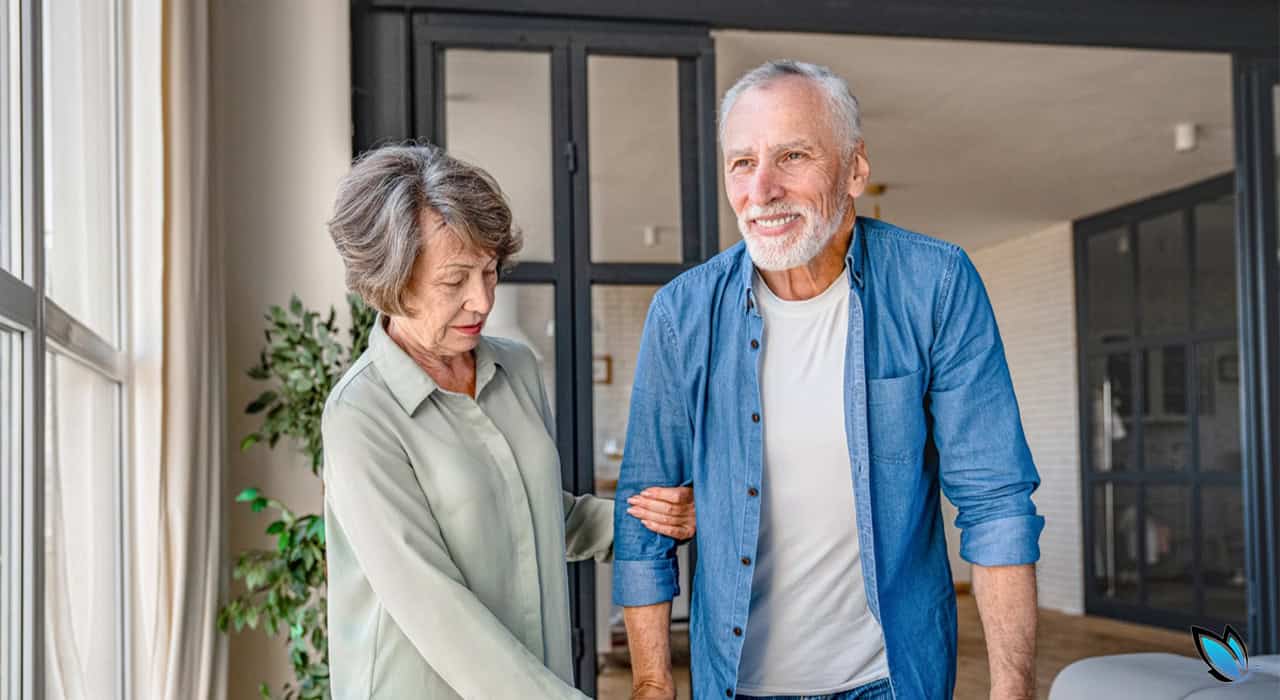 Senior wife taking care of elderly husband on a walker needing assisted living