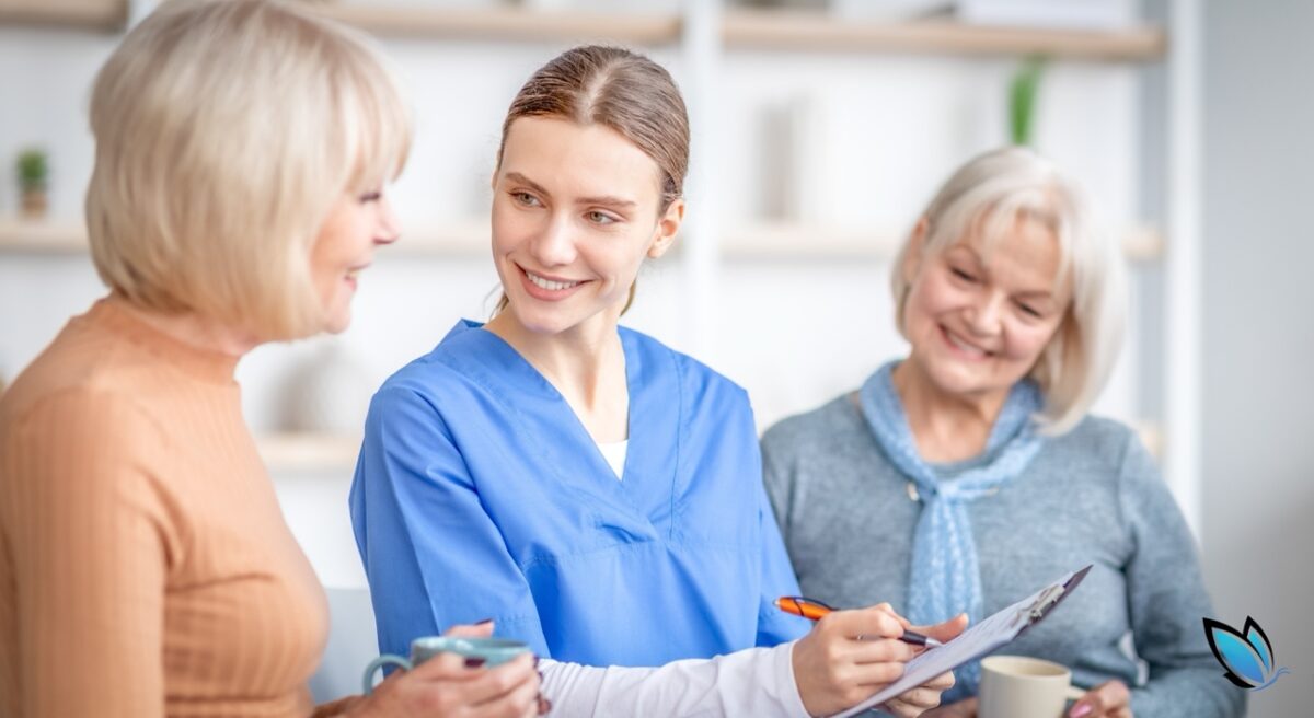 A caregiver going over senior living plans with two possible, senior residents
