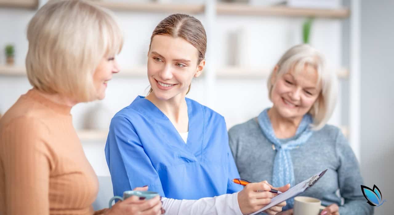 A caregiver going over senior living plans with two possible, senior residents