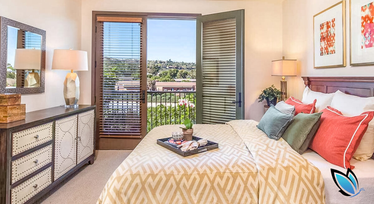 Bright, sunny bedroom in an assisted living community with a great view on the deck