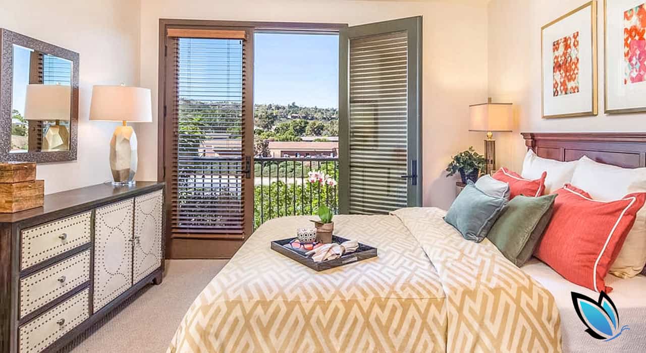 Bright, sunny bedroom in an assisted living community with a great view on the deck
