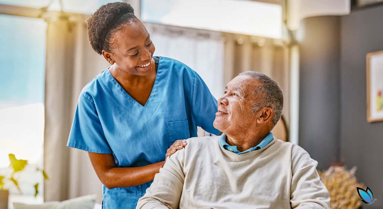 An african american caregiver with an african american Senior resident looking and smiling at each other in an assisted living community
