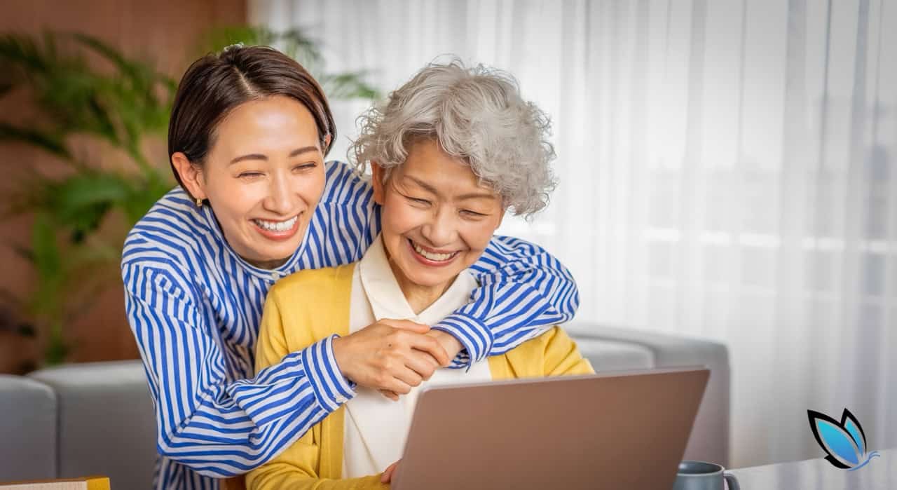 An adult, Asian daughter hugging her Senior mom while they're finding a senior living community