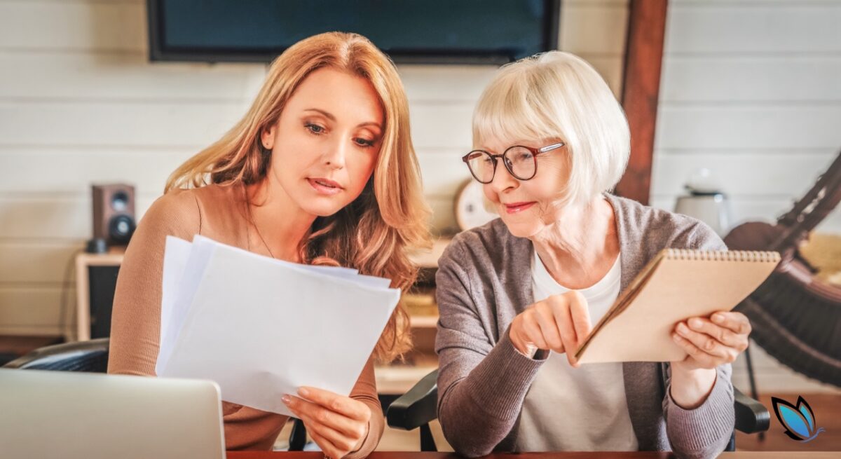 An adult daughter and her senior mother going over the costs of assisted living