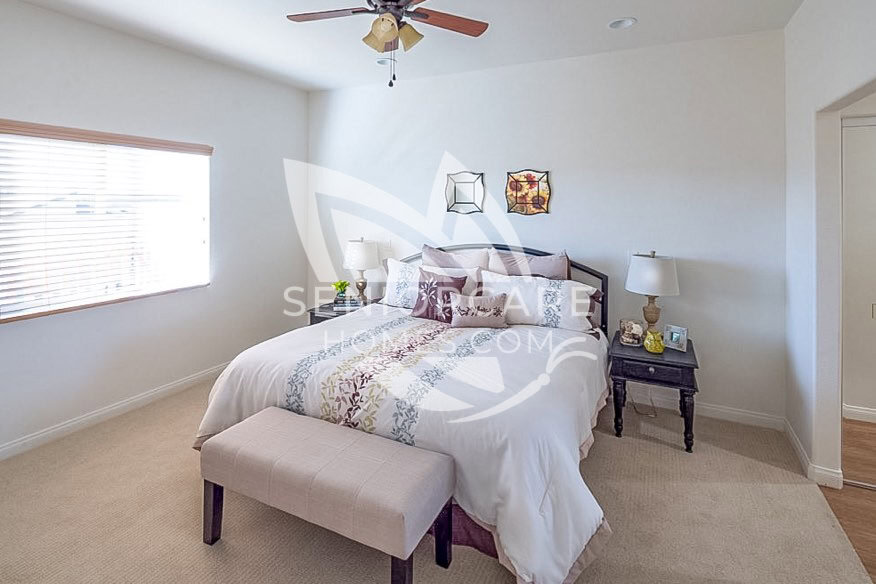 Bedroom with nice lighting at Lantern Crest Senior Living