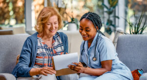 Registered Nurse in an Assisted Living Facility going over admission procedures with the new, Senior resident