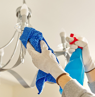 Expert cleaner using cloth and spray for thorough cleaning in Manchester.