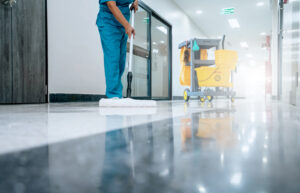 Healthcare facility floor cleaning by professional janitorial staff.