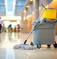 Commercial cleaning mop and bucket in a modern office environment.