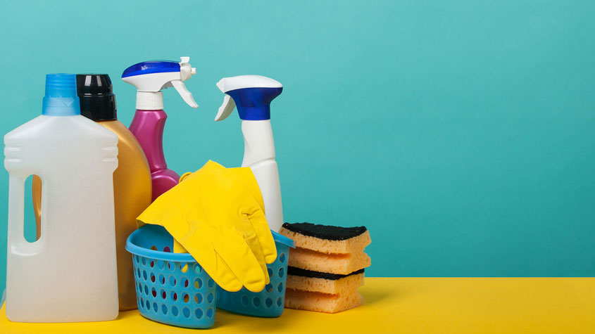 Cleaning supplies including spray bottles, sponges, gloves, and detergents for effective cleaning.