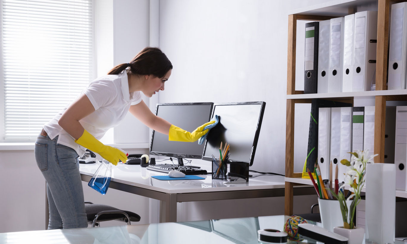 female cleaner in uniform at a cleaning job in a modern office.