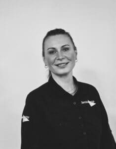 Female team member in uniform representing Servicemaster Manchester's professional cleaning team.