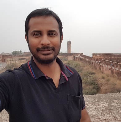 selfie of a gentleman wearing a black polo shirt with dark hair and moustache
