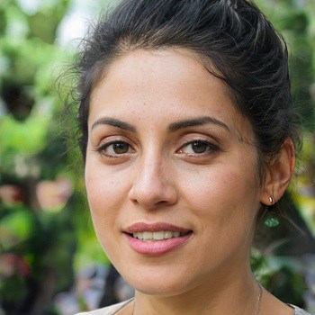 headshot of a woman with dark brown hair pulled back and brown eyes
